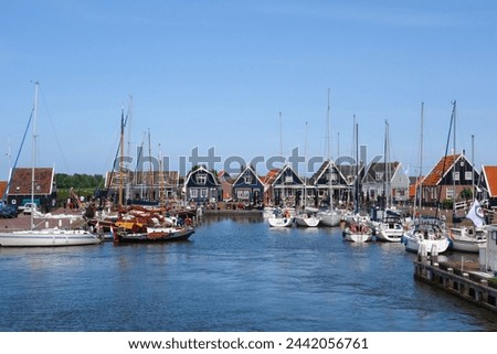 Historic harbor of Marken with sailing ships in Noord - Holland