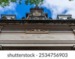 Historic Harvard University entrance with “Enter to Grow in Wisdom” inscription in Cambridge, Massachusetts, USA