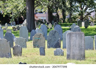 Historic headstones that are so old that they do not have recognizable engravings. These historical graves date back to 1637 and have many direct relations to the Salem Witch Trials. - Shutterstock ID 2047977398