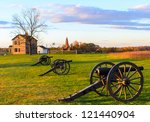 Historic Henry House and cannons at Manassas National Battlefield Park during sunset