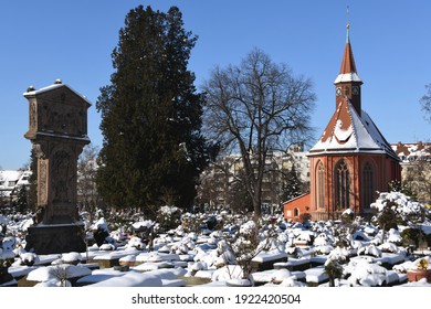 The Historic Johanniskirche From The 13th Century In The St.Johannis District Of Nuremberg With Adam Kraft's First Station Of The Cross In The Johannisfriedhof. The Graves Are Covered With Snow. 