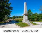 Historic Memorial obelisk in Old North Bridge park in Minute Man National Historical Park, Concord, Massachusetts MA, USA.