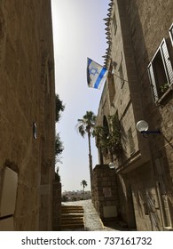 Historic Old City Of Jaffa, A Part Of The City Of TelAviv In Israel. A Flag Of Israel Blowing In The Wind
