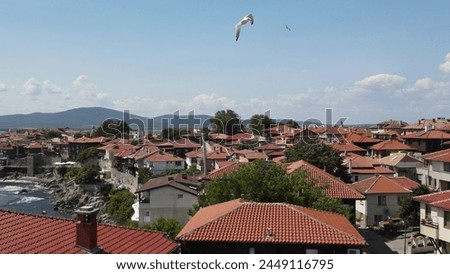Historic old houses with red tiled roofs, architecture on Black Sea coast. Old town of Nessebar, Bulgaria, Panorama. Beautiful and colorful amazing city, view from above