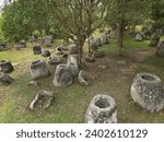 The historic Plain of Jars on a grassy green field in Laos