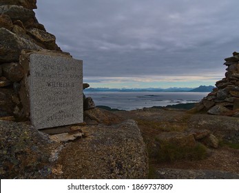 Historic plaque on pile of stones on top of Keiservarden mountain near Digermulen, Hinnøya island, Lofoten, Norway. Text (in focus): German Emperor Wilhelm II visited this place in 1903.