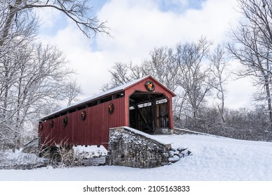 Historic Pool Forge Covered Bridge with snow on a bright winter day in Lancaster County, Pennsylvania, USA - Shutterstock ID 2105163833