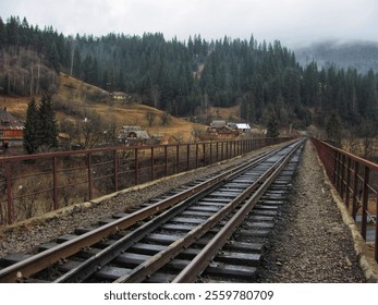 A historic railroad bridge stretches across a scenic river valley - Powered by Shutterstock