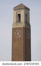 Historic Red Brick Clock Tower Against Blue Sky