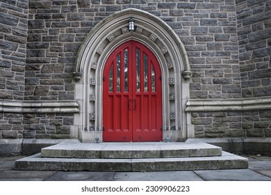 Historic red church door with stone background