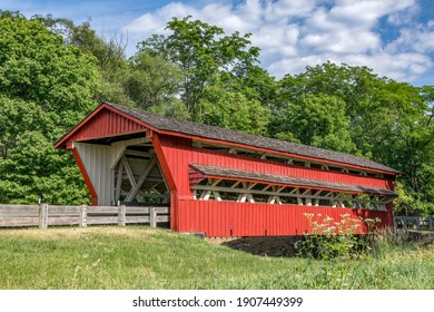 Historic red Spain Creek Covered Bridge, on a rural country road in Union County, Ohio, was built in 1870.