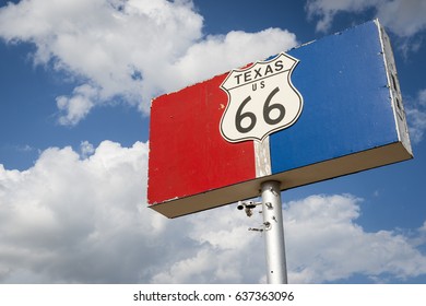 Historic Road 66 Road Sign Against A Blue Sky With Clouds In The State Of Texas, USA; Concept For Travel In The USA And Road Trip