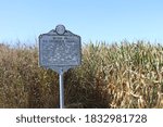 Historic roadside marker with cornfield on country road in West Virginia
