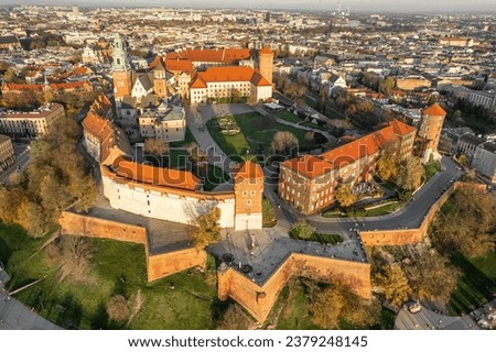 Historic royal Wawel castle in Cracow at sunrise, Poland. Aerial view of the Krakow skyline with Wawel Hill, Cathedral, Royal Wawel Castle, defensive walls. Krakow old town from above