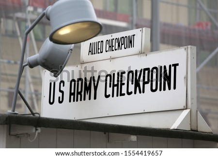 historic signpost in the old border point between East Berlin and West Berlin called Check Point Charlie in use during the Cold War in Europe