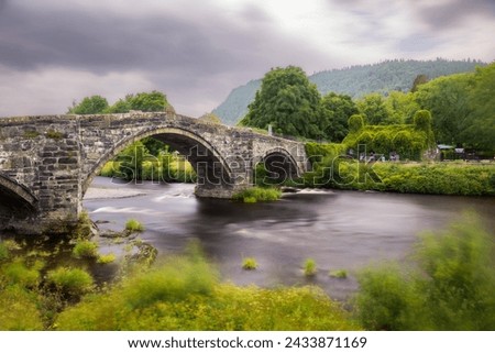 Historic steep stone arch bridge crossing a river - Pont Fawr (Inigo Jones Bridge) Llanrwst North Wales