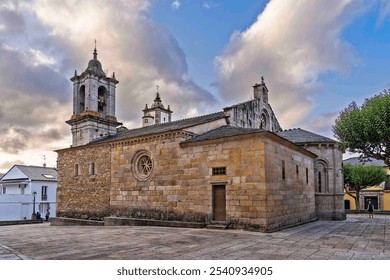 A historic stone church with two bell towers, set against a dramatic sky. The building features intricate architectural details and is surrounded by a spacious plaza. - Powered by Shutterstock