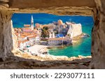 Historic town of Budva architecture and beach view through stone window, archipelago of Montenegro