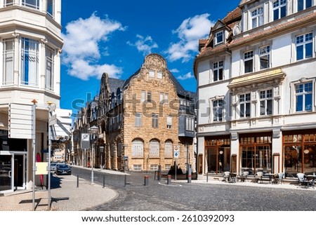 Historic town scape in Gotha, Thuringia, with sandstone building and charming cafes under blue summer skies
