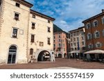 Historic town square Piazza III Novembre with Fontana di acqua potabile and palazzo Pretorio in idyllic lakeside town Riva Del Garda at lake Garda, Trentino, Italy. Mediterranean architecture