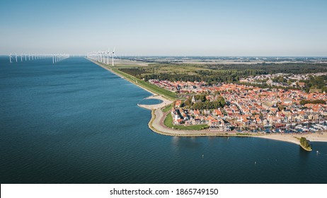Historic Town Of Urk In Flevoland, The Netherlands With An Offshore Wind Turbine Farm On The Background. Aerial View.
