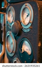 Historic train engine control dashboard with vintage gauges and brass fittings. Industrial heritage machinery showcasing classic engineering design. Angled shot.
