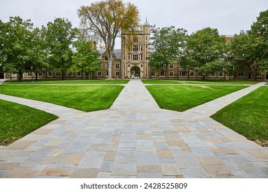 Historic University Building with Autumnal Trees and Pathways - Powered by Shutterstock