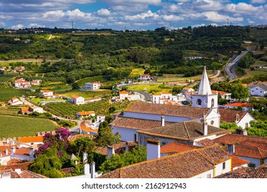 Historic walled town of Obidos, near Lisbon, Portugal. Beautiful streets of Obidos Medieval Town, Portugal. Street view of medieval fortress in Obidos. Portugal. - Shutterstock ID 2162912943