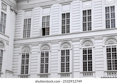 Historic White Facade with Ornate Details and Open Window, Perfect for Architecture Themes or Copy Space in Urban Travel Ads - Powered by Shutterstock