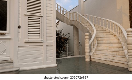 Historic white wooden mansion with white marble staircase from the side, Wooden louvered windows - Powered by Shutterstock