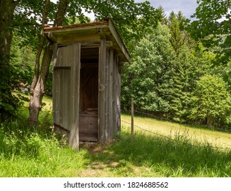 Historic Wooden Pit Latrine In Sunny Green Ambiance