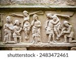 Historical 16th century calvary relief depicting biblical scenes located in Guehenno, Brittany, France. Detailed stone carving with religious significance.