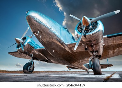 historical aircraft on a runway against a dramatic sky