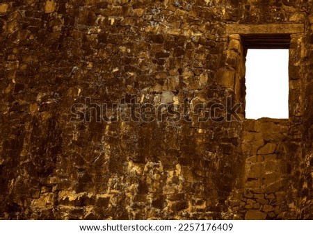 historical background of ruins of an ancient fortress. empty window frame. Ancient window from the ruins of an old castle. grey stone wall backdrop. mock up.  