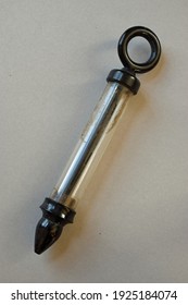 Historical Enema Syringe Against A Gray Background