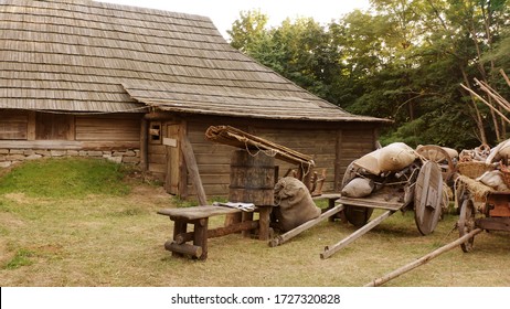 Historical log house. Rural wooden trolleys. Very steep roofs of houses.