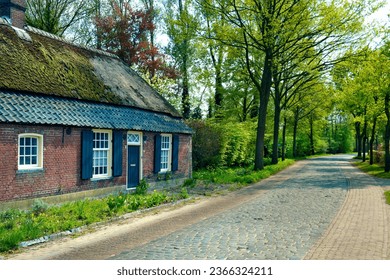 historical long facade farmhouse on an old cobbled road in Nuenen the Vincent van Gogh village in North Brabant