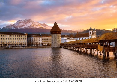 Historical Lucerne Old town with wooden Chapel Bridge and Pilatus mountain, Switzerland, in dramatic sunset light - Powered by Shutterstock