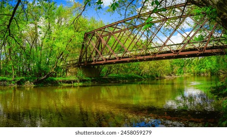 Historical railroad bridge over Big Sioux River converted into pedestrian footpath and bike trail in the Sioux Falls City Green Space Conservation Park, South Dakota - Powered by Shutterstock