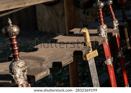 Historical reenactment weaponry featuring sharp blades and ornate handles