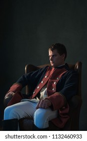 Historical Regency Man Sitting In Chair Looking Aside.