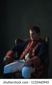 Historical Regency Man Sitting In Chair Looking Aside.