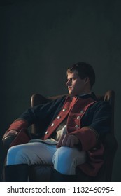 Historical Regency Man Sitting In Chair Looking Aside.