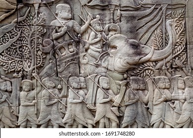 Historical Relief With Khmer Soldiers And Elephants On The 12th Century Wall Of Bayon Temple, Cambodia. Historical Artwork In Angkor. UNESCO World Heritage Site.