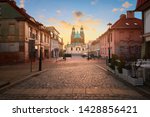 Historical road leading towards Gniezno Royal Cathedral on a sunset. Gniezno town, former capital of Poland.