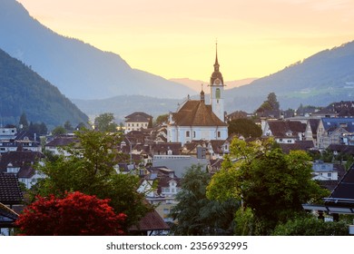 Historical Schwyz city's Old town in swiss Alps mountains in sunset light, central Switzerland