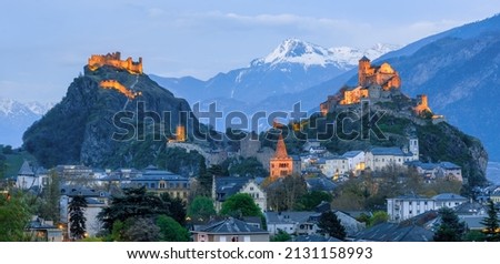 Historical Sion town with its two castles, Chateau de Tourbillon and Valere Basilica, spectacular set in the swiss Alps mountains, canton Valais, Switzerland, in blue evening light