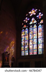 Historical Stained Glass Window With Religious Scene And Reflection On  Wall And Icons