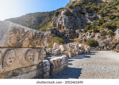 Historical Stone faces bas relief and ancient theater at Myra ancient city. Rock-cut tombs Ruins in Lycia region, Demre, Antalya, Turkey.  