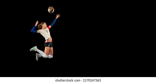 Hit the ball in jump. Dynamic portrait of professional volleyball player in sports uniform playing volleyball isolated on dark background. Sport, healthy lifestyle, team, action, motion concept. - Powered by Shutterstock